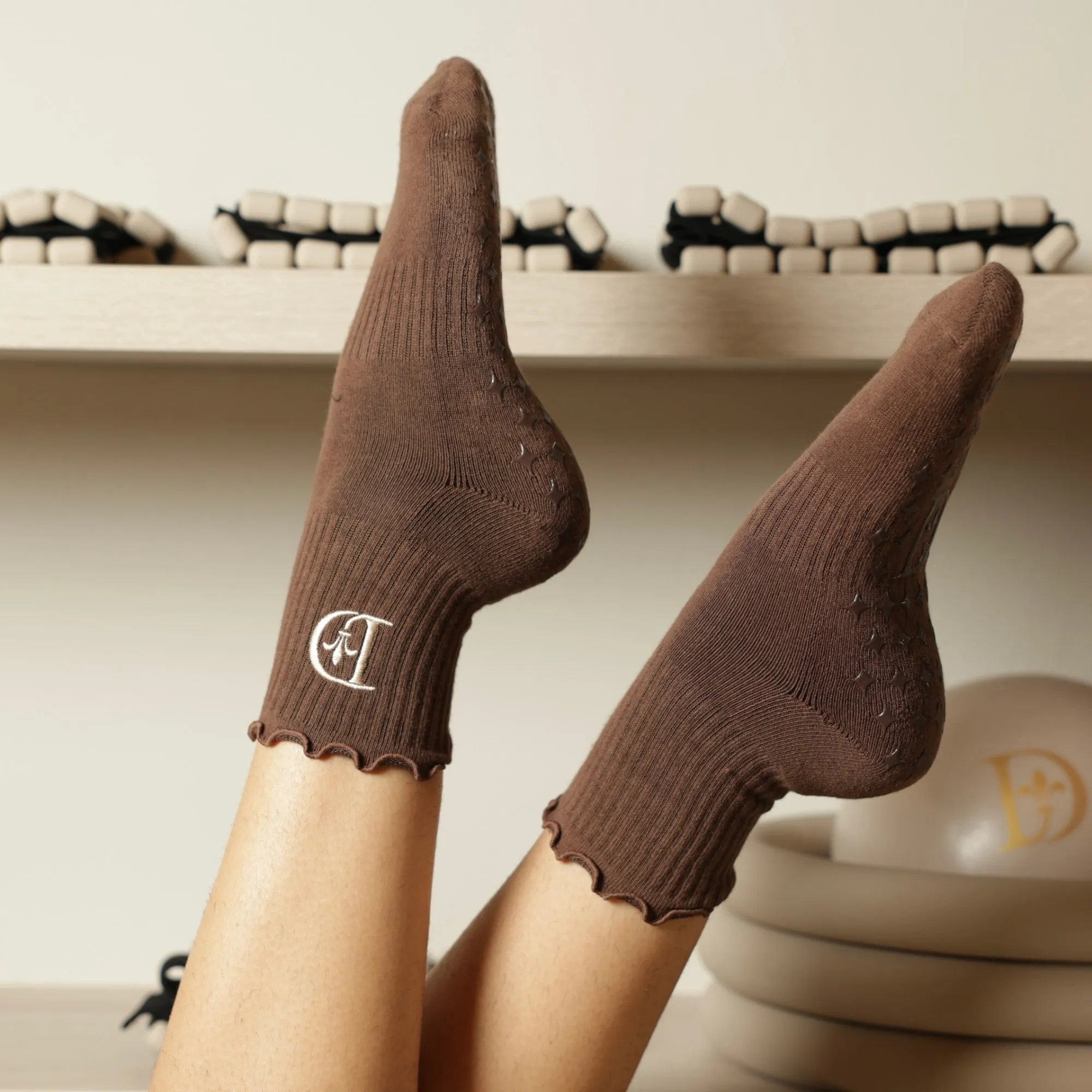 Mocha grip socks with the embroidered Dermabless monogram.